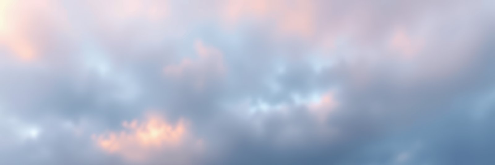 Beautiful pastel clouds at sunset creating a serene sky over a tranquil landscape